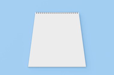 Üzerinde mavi arka plan beyaz boş defter metal spiral ile bağlı