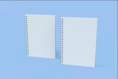 İki defter spiral ile mavi arka plan üzerinde bağlı