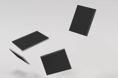 Beyaz arka plan üzerinde dört defter spiral ile bağlı