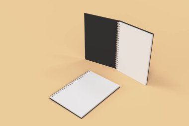 Turuncu zemin üzerine iki defter spiral ile bağlı