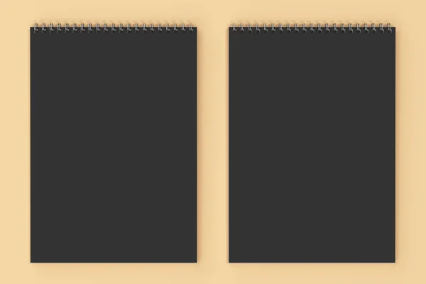 Schwarzes Notizbuch mit Metallspirale, gebunden auf orangefarbenem Hintergrund — Stockfoto