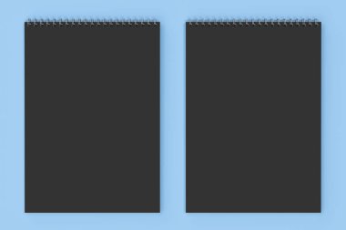 Mavi zemin üzerine boş siyah defter metal spiral ile bağlı