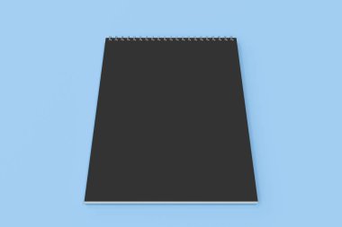 Mavi zemin üzerine boş siyah defter metal spiral ile bağlı