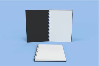 İki defter spiral ile mavi arka plan üzerinde bağlı