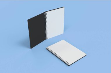 İki defter spiral ile mavi arka plan üzerinde bağlı