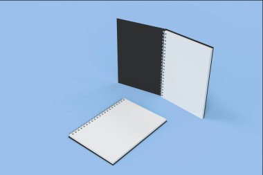 İki defter spiral ile mavi arka plan üzerinde bağlı