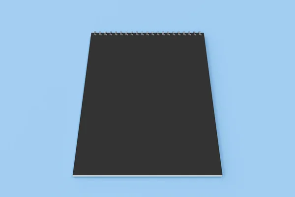 Cuaderno negro en blanco con espiral metálica encuadernada sobre fondo azul — Foto de Stock