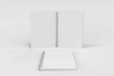 Beyaz arka plan üzerinde iki defter spiral ile bağlı