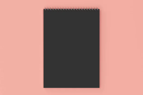 Caderno preto em branco com espiral de metal encadernado no fundo vermelho — Fotografia de Stock