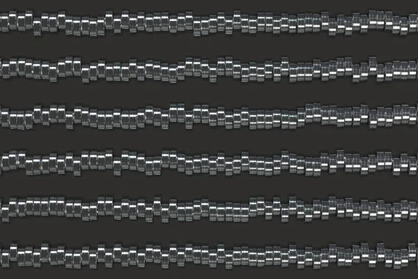 Pattern of brushed metal cylinder tablets on black background