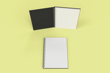 Sarı arka plan üzerinde iki defter spiral ile bağlı