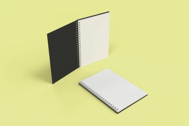 Sarı arka plan üzerinde iki defter spiral ile bağlı