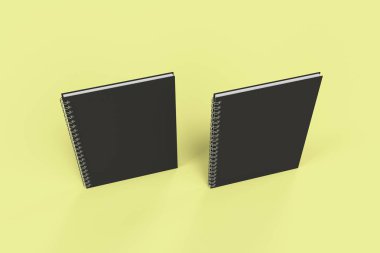 Sarı arka plan üzerinde iki defter spiral ile bağlı