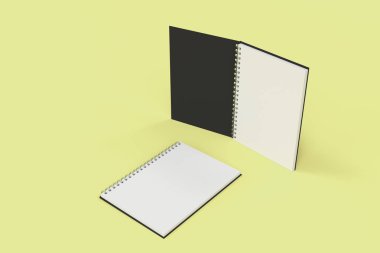 Sarı arka plan üzerinde iki defter spiral ile bağlı