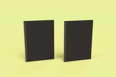 Sarı arka plan üzerinde iki defter spiral ile bağlı