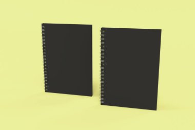 Sarı arka plan üzerinde iki defter spiral ile bağlı