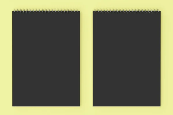 Üres fekete Jegyzetfüzet-val fém spirál kötött a sárga háttér mintázata — Stock Fotó