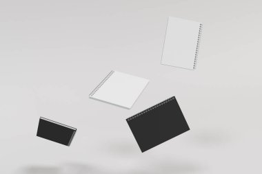 Beyaz arka plan üzerinde dört defter spiral ile bağlı