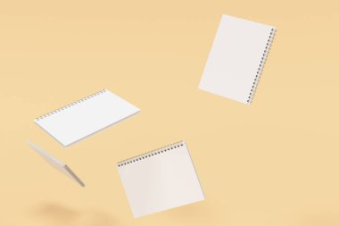 Turuncu zemin üzerine dört defter spiral ile bağlı