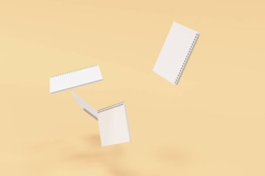 Turuncu zemin üzerine dört defter spiral ile bağlı