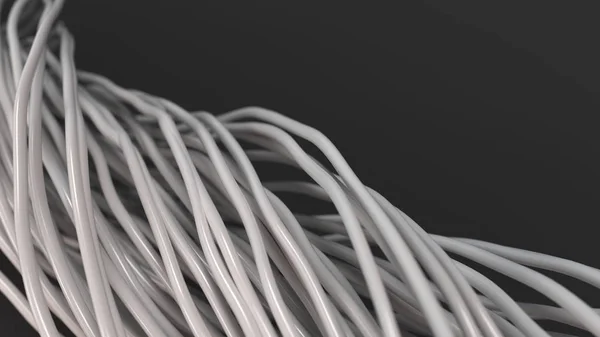 Twisted white cables and wires on black surface
