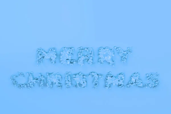 Liquid blue Merry Christmas words with drops on blue background — Stock Photo, Image