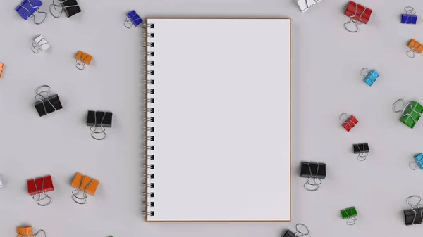 Caderno espiral em branco com grampos de aglutinante coloridos na mesa branca — Fotografia de Stock