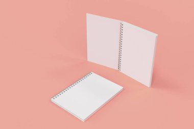 Kırmızı zemin üzerine iki defter spiral ile bağlı