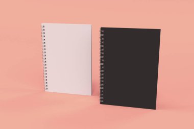 Kırmızı zemin üzerine iki defter spiral ile bağlı