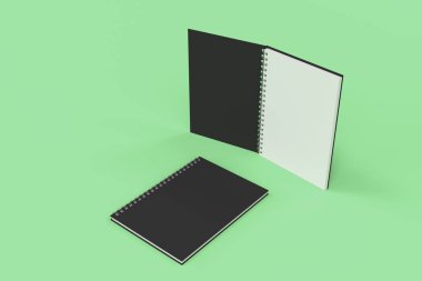 Yeşil arka plan üzerinde iki defter spiral ile bağlı