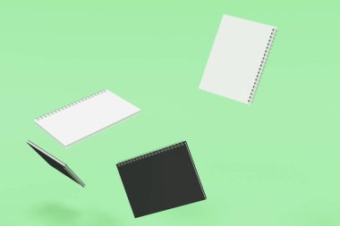 Yeşil arka plan üzerinde dört defter spiral ile bağlı