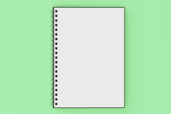 Opend notebook spiral bound on green background