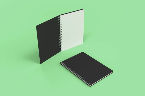 Twee laptops met spiraal gebonden op groene achtergrond — Stockfoto
