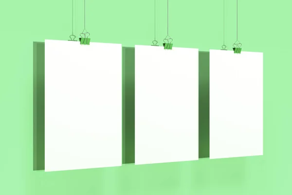 Three blank white posters with binder clip mockup on green backg — Stock Photo, Image