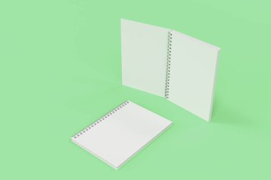 Yeşil arka plan üzerinde iki defter spiral ile bağlı