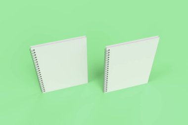 Yeşil arka plan üzerinde iki defter spiral ile bağlı