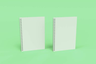 Yeşil arka plan üzerinde iki defter spiral ile bağlı