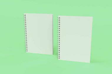 Yeşil arka plan üzerinde iki defter spiral ile bağlı