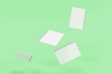 Yeşil arka plan üzerinde dört defter spiral ile bağlı