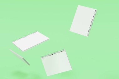 Yeşil arka plan üzerinde dört defter spiral ile bağlı