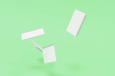 Yeşil arka plan üzerinde dört defter spiral ile bağlı