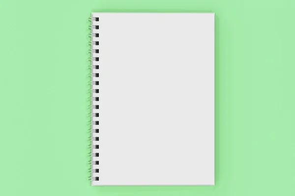 Ze spiralą notebook opend na zielonym tle — Zdjęcie stockowe