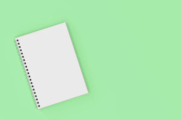 Ze spiralą notebook opend na zielonym tle — Zdjęcie stockowe