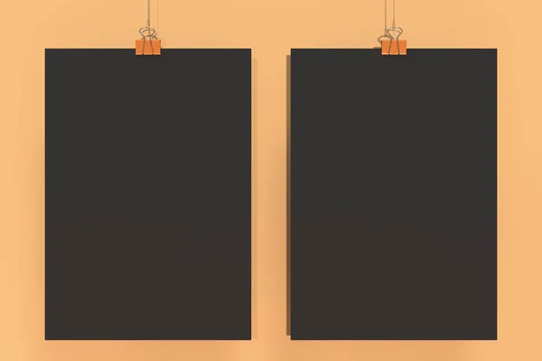 Dvě prázdné černé plakáty s binder klip maketa na oranžové pozadí — Stock fotografie