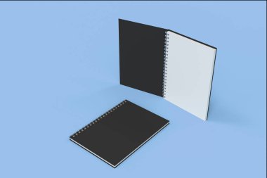 İki defter spiral ile mavi arka plan üzerinde bağlı