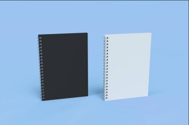 İki defter spiral ile mavi arka plan üzerinde bağlı