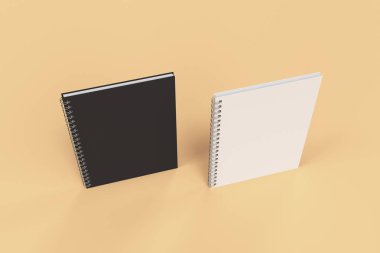 Turuncu zemin üzerine iki defter spiral ile bağlı