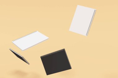 Turuncu zemin üzerine dört defter spiral ile bağlı