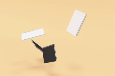 Turuncu zemin üzerine dört defter spiral ile bağlı