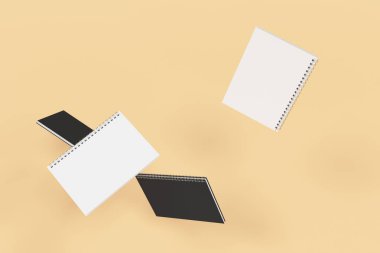 Turuncu zemin üzerine dört defter spiral ile bağlı